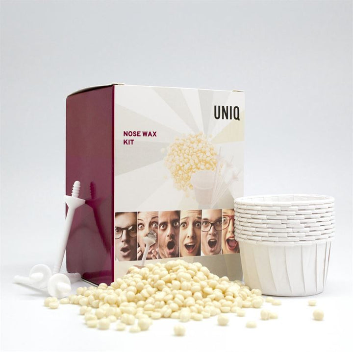 The UNIQ Nose Wax Kit by UNIQ provides easy nose hair removal with white wax beads, plastic applicators, paper cups, and fun packaging featuring expressive faces and Nose Wax Kit text.